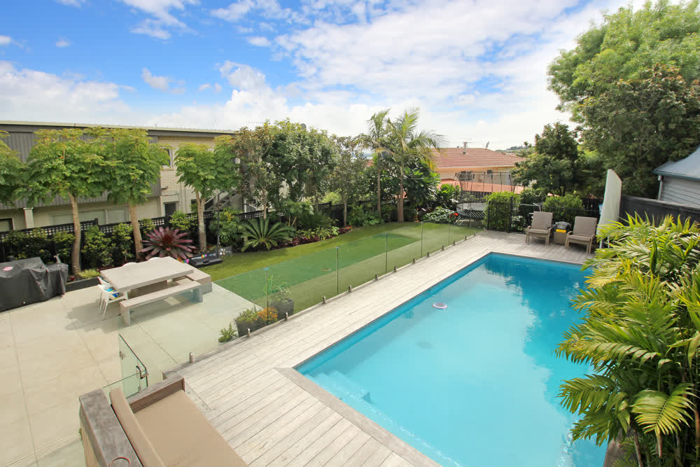 Compact lawn by patio and pool